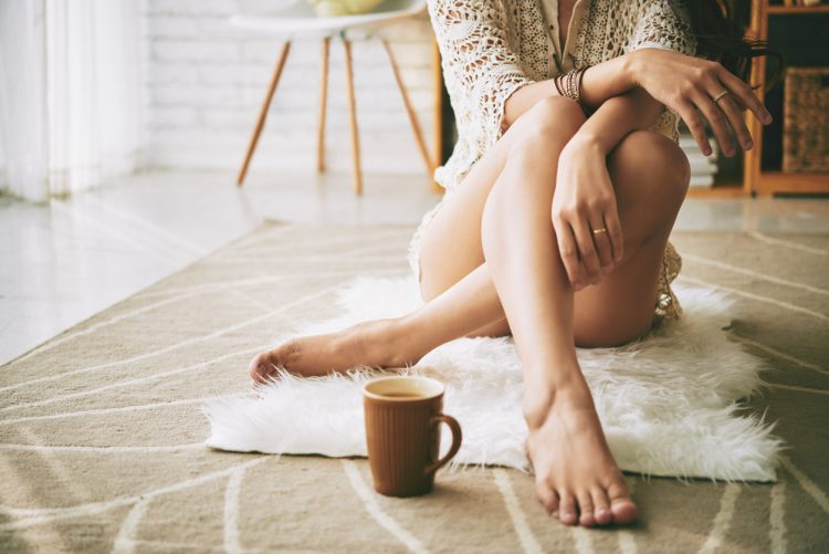 Woman Sitting on Floor Drinking Coffee