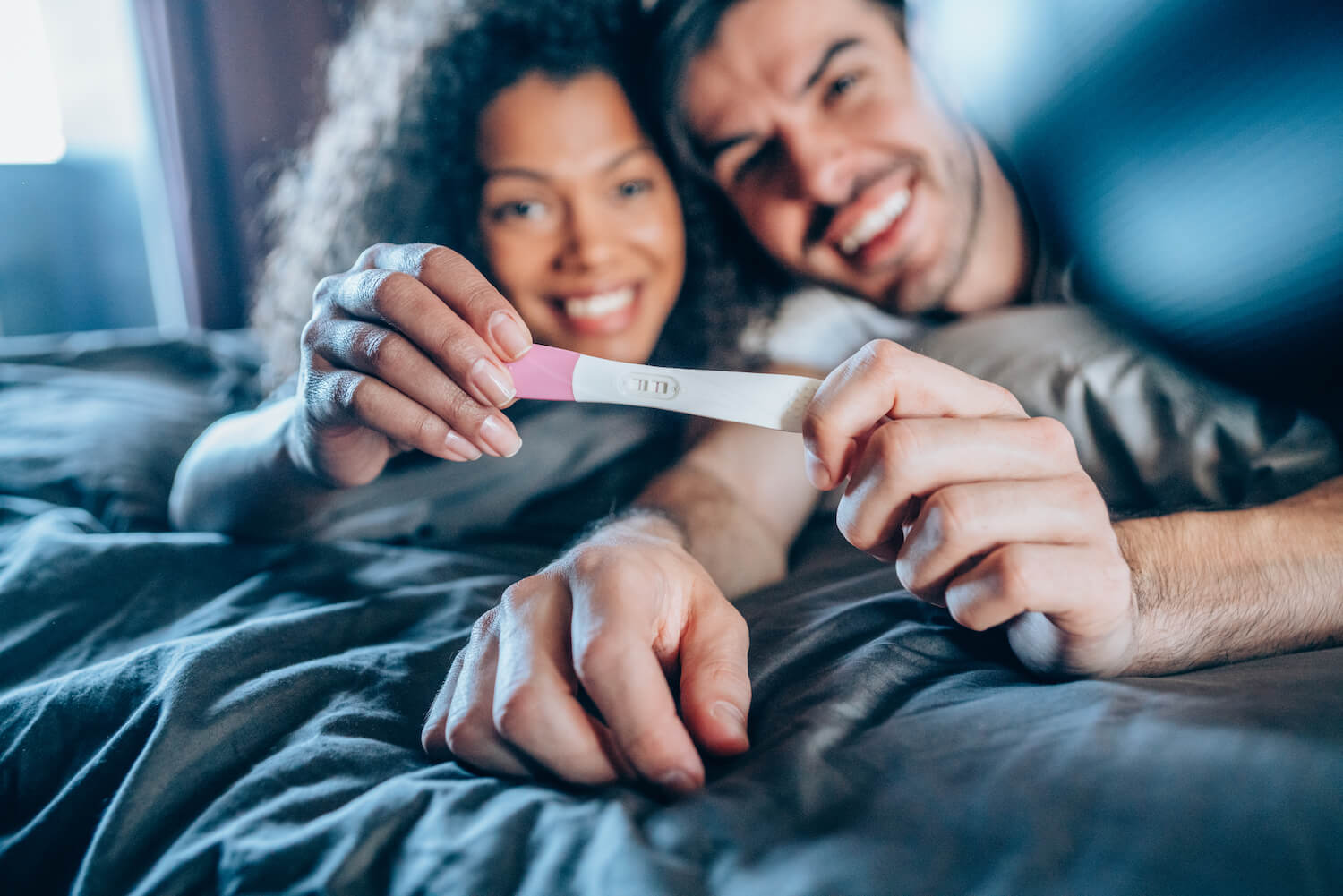 Couple holding positive pregnancy test