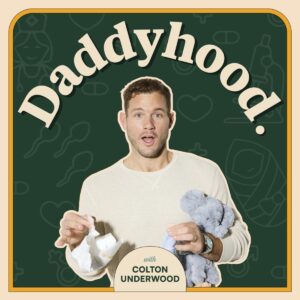 A surprised man in a cream sweater holds a diaper and a plush toy. The word “Daddyhood.” curves above him. The background features line drawings of baby items. Text below reads, “with Colton Underwood.”.