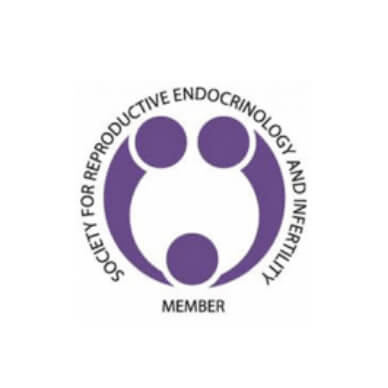 Logo of the Society for Reproductive Endocrinology and Infertility, featuring three purple circular shapes arranged to resemble a family, with the organization’s name written in a circle around the design.