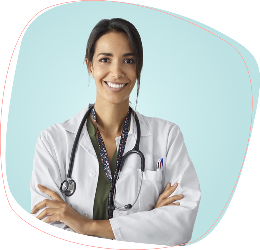 A smiling woman wearing a white lab coat and a stethoscope around her neck stands with her arms crossed in front of a light blue background.