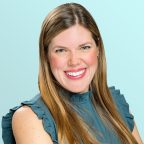 A woman with long, straight light brown hair smiles at the camera. She is wearing a ruffled, sleeveless teal blouse and is posed against a light blue background.