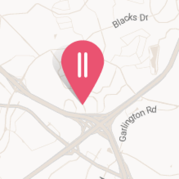 Map with a pink location pin near the intersection of Garlington Road, Blacks Drive, Pelham Road, and Miller Road, in the Woodberry area.